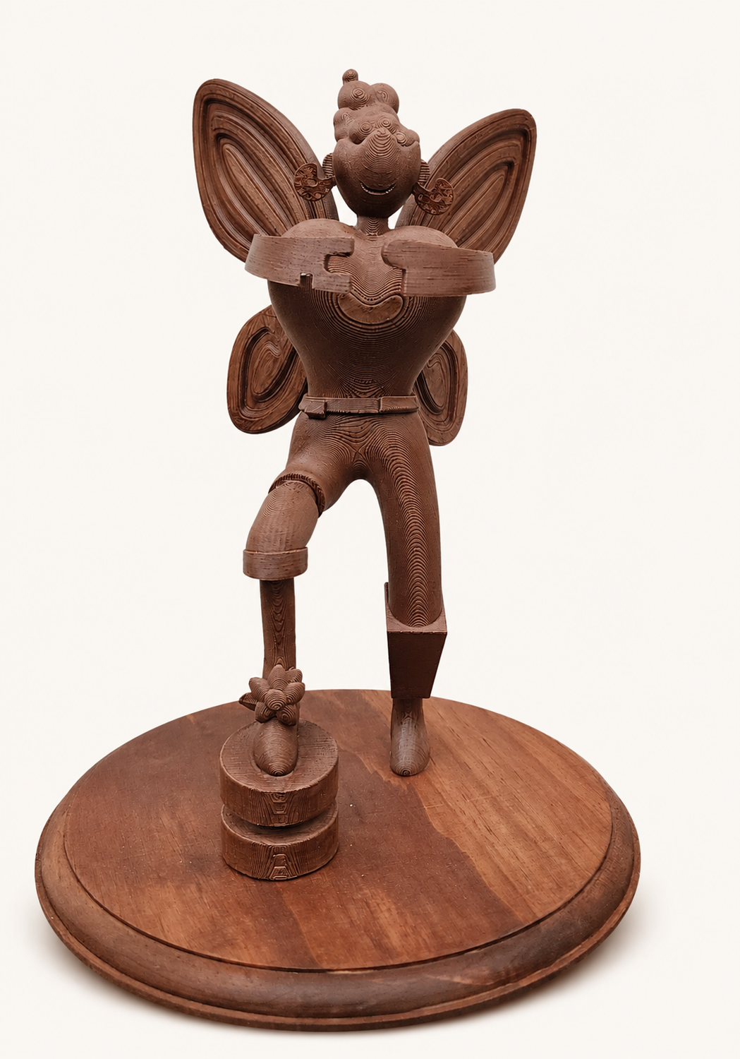 A real sculpture with a cloud-shaped head, heart body, puzzle hands and butterfly wings